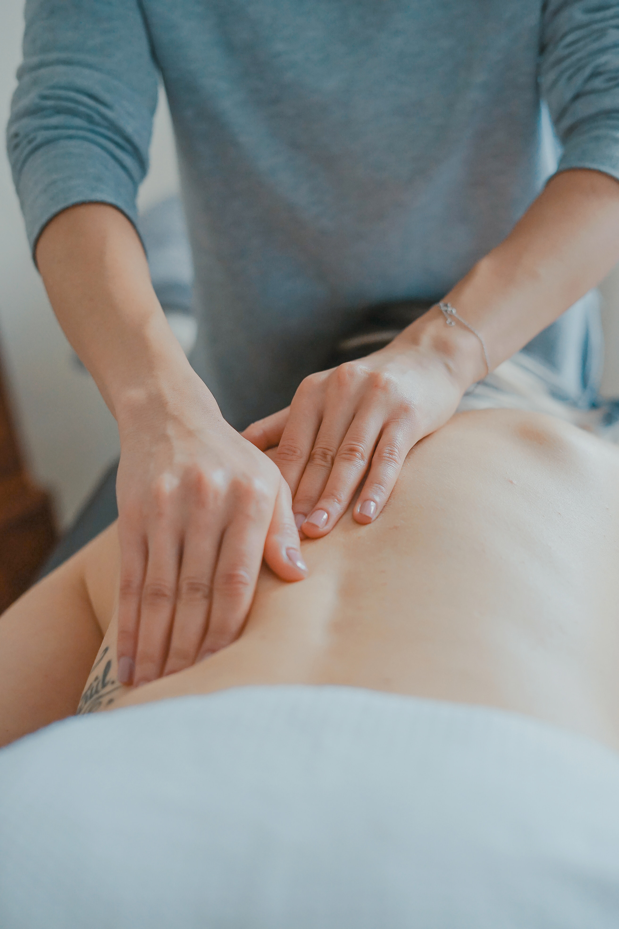 A person is doing some massage on the back of someone.